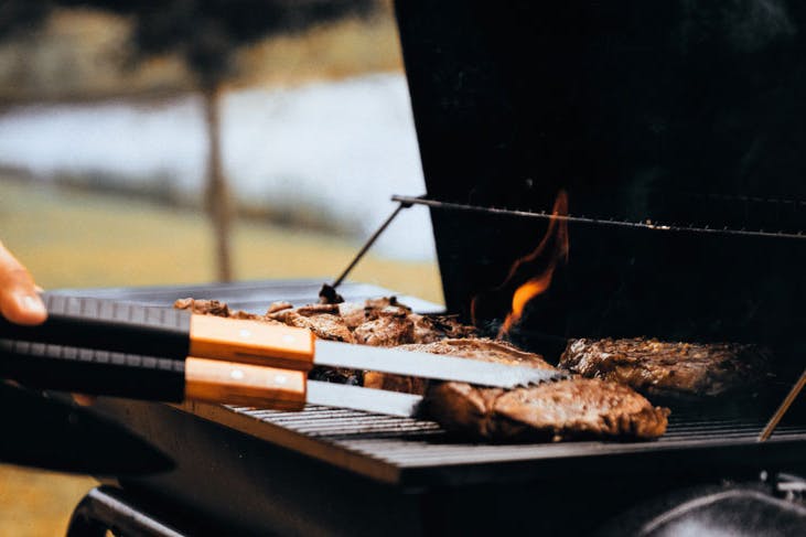 Meats on a BBQ in a park